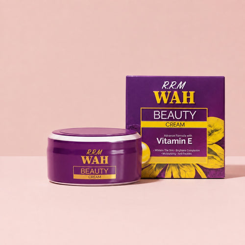 A purple jar of R.R.M WAH Beauty Cream with Vitamin E is shown next to its matching purple and yellow packaging box on a solid light pink background.